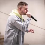 A man sings into a microphone