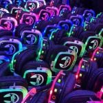 A selection of headphones, each brightly lit in neon colours